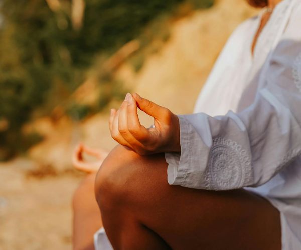 Close-up of a person's hands in a meditative yoga mudra.